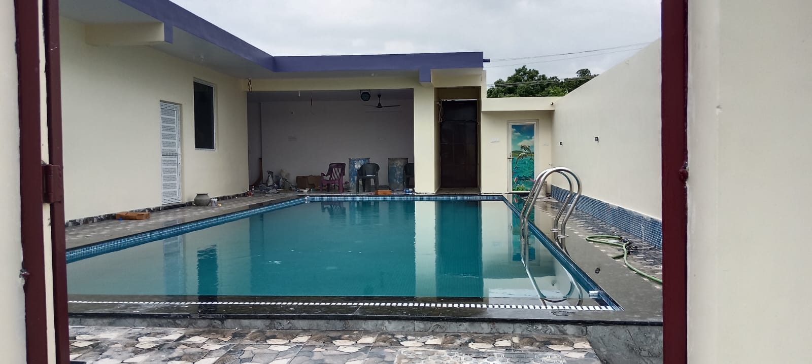 Swimming pool with pool ladder